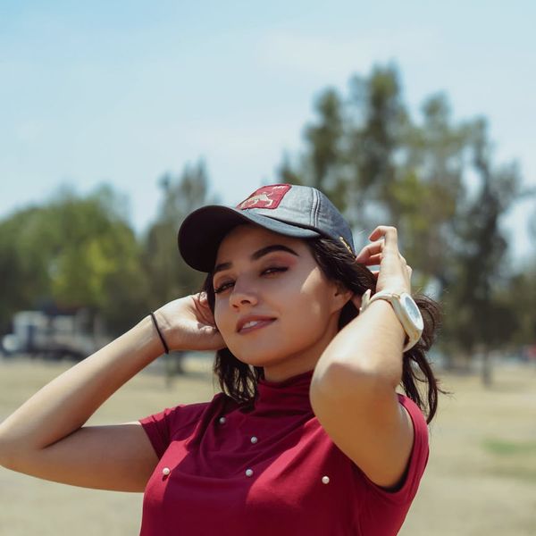 Smiling person with closed eyes in a sunny park